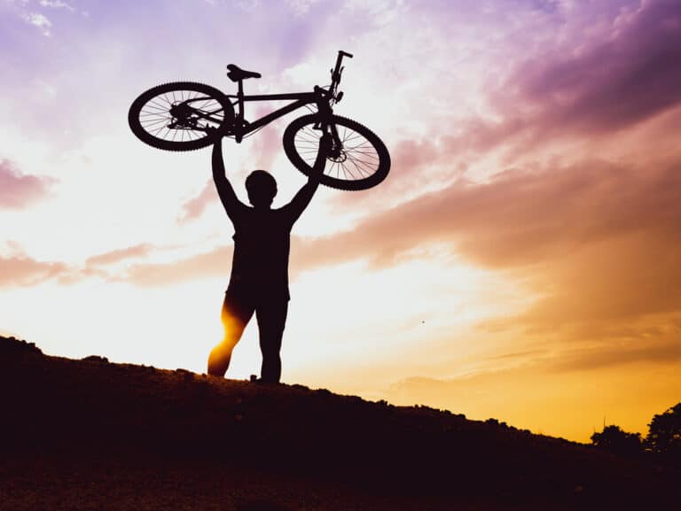 mountain biker's lifts the bike